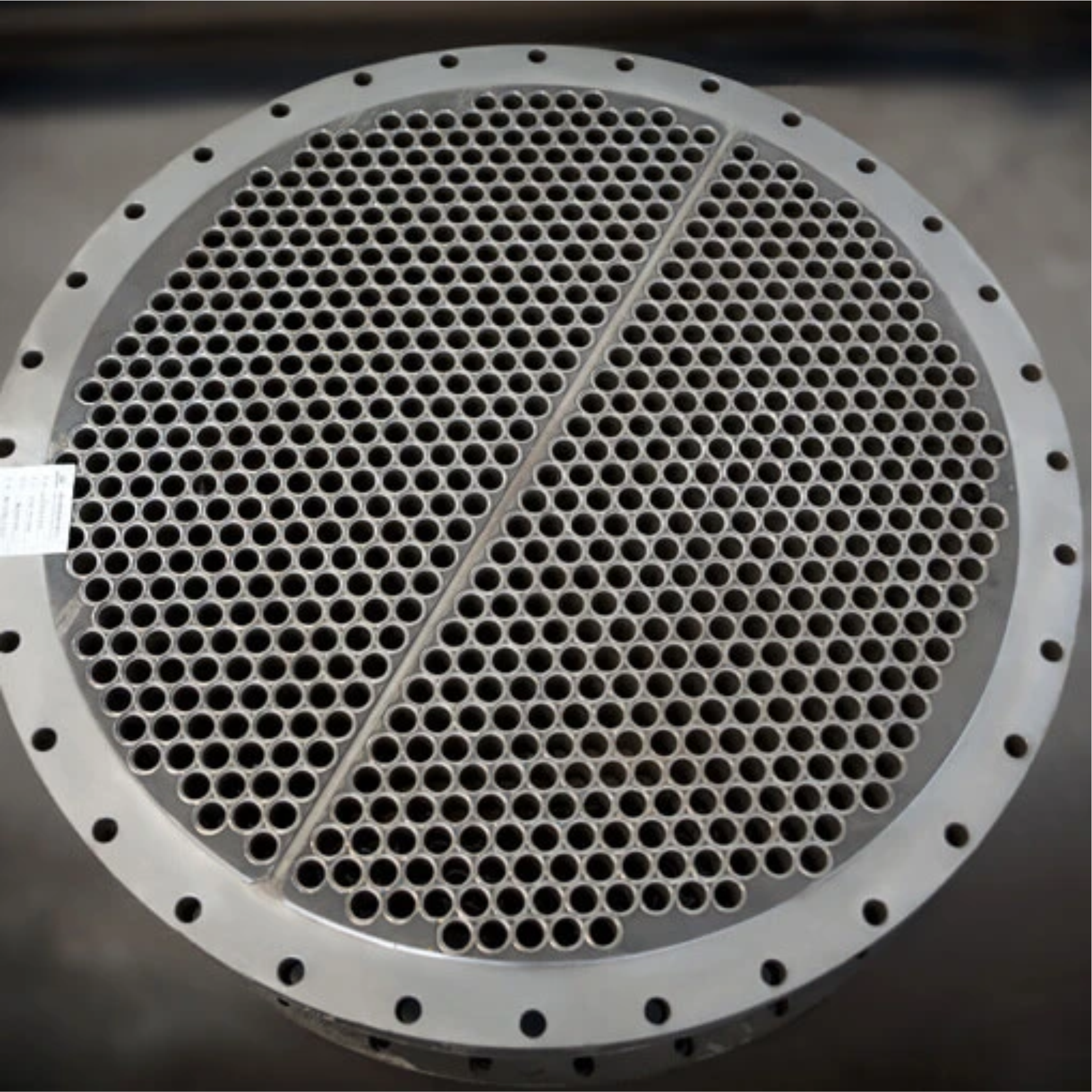 Steel tube sheet with holes drilled in it